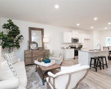 Living room featuring light wood-style flooring and recessed lighting
