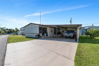 Manufactured / mobile home featuring a carport and