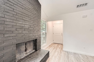 Unfurnished living room with lofted ceiling, ligh