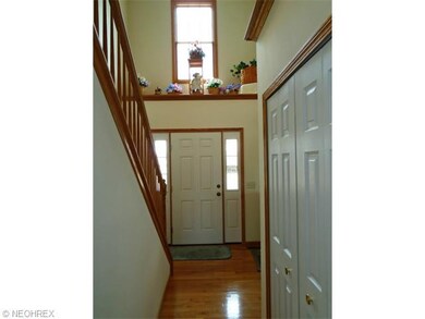 The 2-story center hall foyer has hardwood floors 