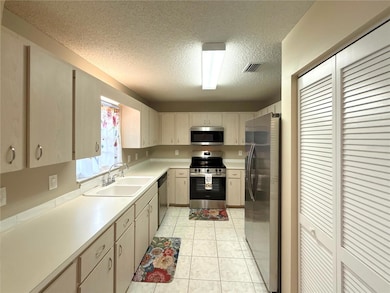 Updated kitchen with new stainless steel appliances, loads of cabinet space, and convenient pantry