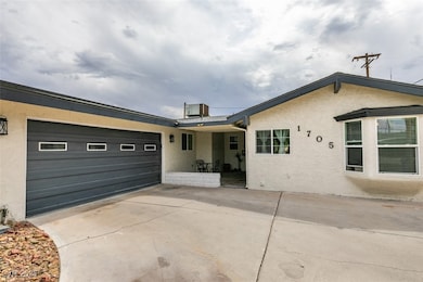 View of front facade featuring stucco siding, an attached garage, and concrete driveway