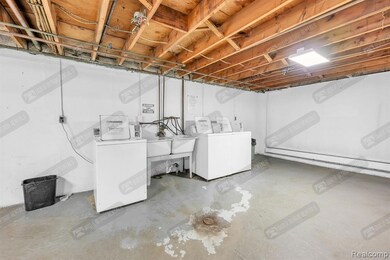 Unfinished below grade area featuring washer and dryer and baseboard heating