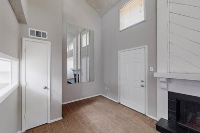 Foyer featuring baseboards, a fireplace, a texture