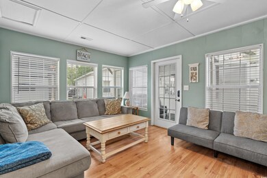Living area featuring light wood-type flooring and a ceiling fan