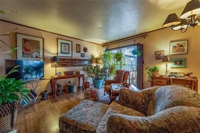 Living room featuring ornamental molding, hardwood