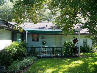 Nice covered back porch to admire your back yard oasis.