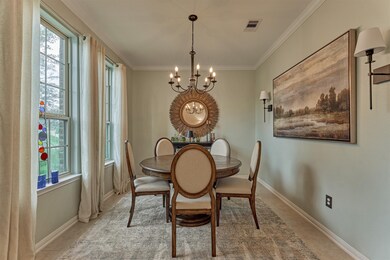 Formal dining room is naturally lit and framed wit