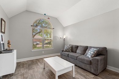 This cozy living room features a vaulted ceiling,