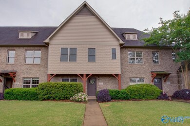 Exquisite landscaping and a cozy front porch invit