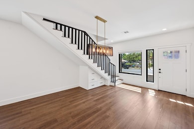 Foyer entrance with baseboards, visible vents, re