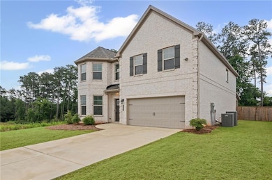 View of front of property featuring brick siding, an attached garage, driveway, and cooling unit