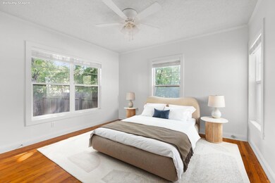 Bedroom featuring wood finished floors, crown mol