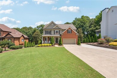 Craftsman house featuring concrete driveway, covered porch, a front yard, brick siding, and a garage