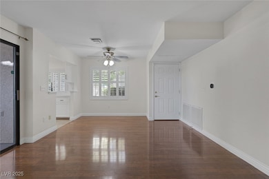 Entryway with a ceiling fan, wood-type flooring, a