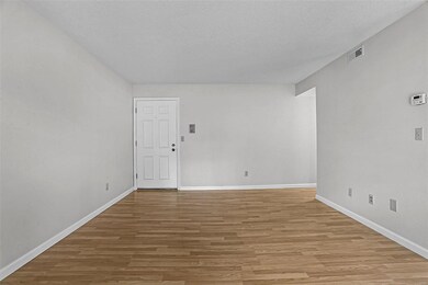 Spacious living room with laminate flooring.