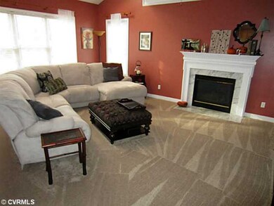 Den/Family/Great Room - Family Room is Sun-Filled by the Windows along the Back and beautifully accentuated by the Crown Molding and Upgraded Neutral Carpet.