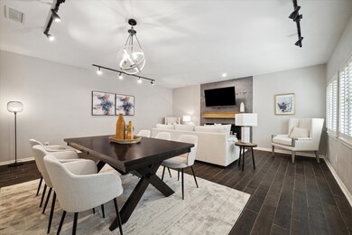 Large living/dining area with a wood burning firep