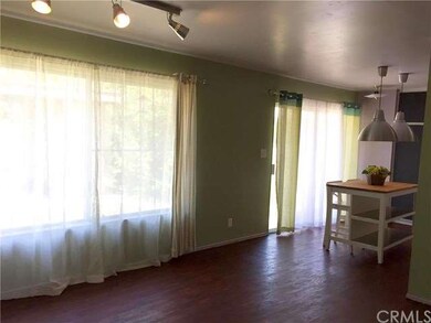 Living room has large window, tract lighting and l