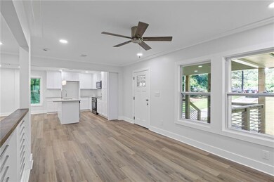 Unfurnished living room with healthy amount of natural light, ceiling fan, ornamental molding, light wood-style floors, and recessed lighting