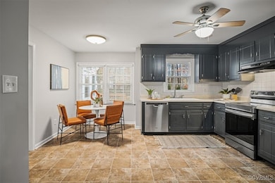 Kitchen with ceiling fan, stainless steel applianc