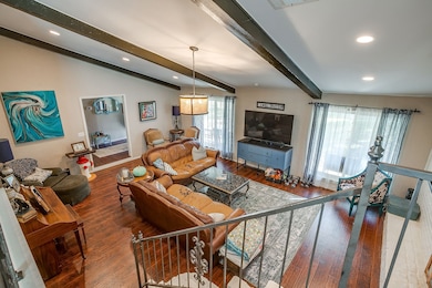 Living area with hardwood / wood-style flooring and recessed lighting