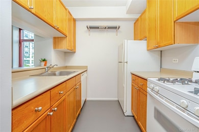 Kitchen featuring white appliances and light countertops