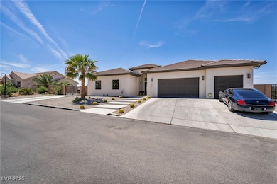 View of front of home featuring a garage, fence, s