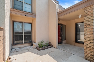 Entrance to property with a patio and stucco siding