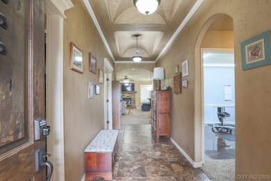 Entrance to home with cross-vaulted ceiling, crown