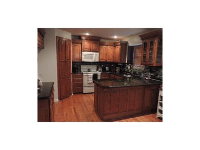 Kitchen with hardwood floors, nice cabinetry and g