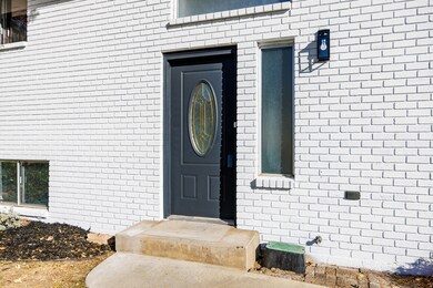 Entrance to property featuring brick siding
