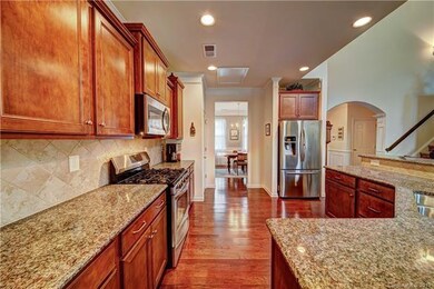 Kitchen with granite countertops, tile backsplash 