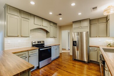 Kitchen with decorative backsplash, butcher block 