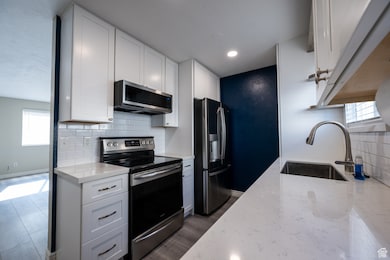 Kitchen featuring plenty of natural light, appliances with stainless steel finishes, and tasteful backsplash