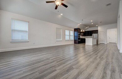 Unfurnished living room with lofted ceiling, a ce