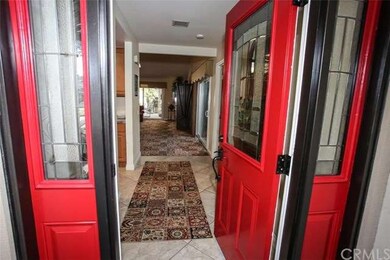 The custom entry door features leaded glass and si