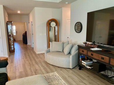 Living room with light hardwood / wood-style floor