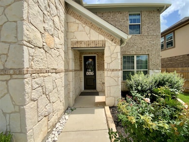 Doorway to property featuring brick siding and st
