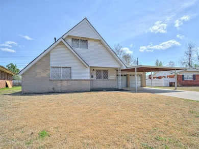 View of front of house featuring fence, an attache
