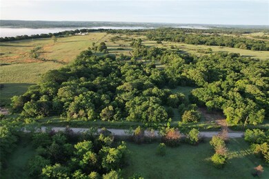Aerial view of property's location with a large body of water