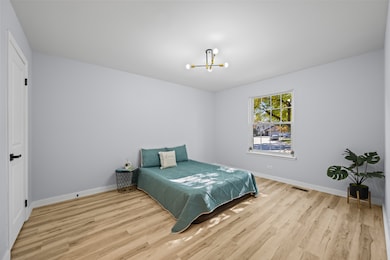 Inviting primary bedroom with large window, update