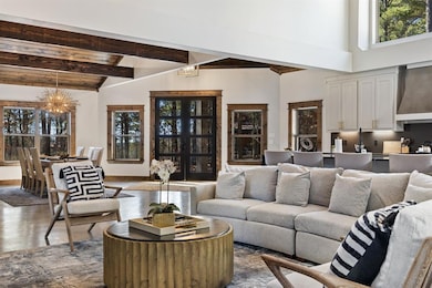 Living room with beamed ceiling, high vaulted ceil