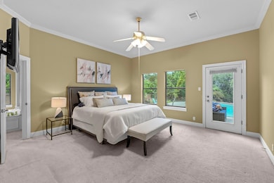 Carpeted bedroom featuring ornamental molding, ac