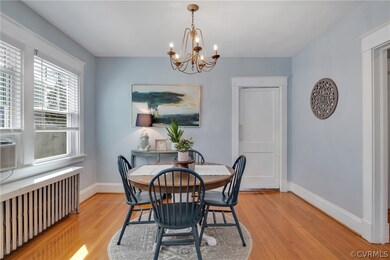 Dining room with a notable chandelier, light wood-