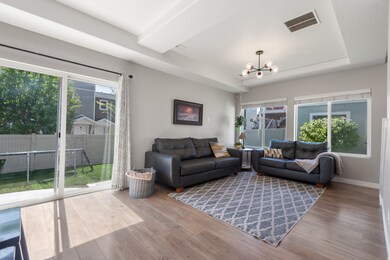 Living area with wood finished floors and a chandelier