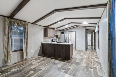 The view to the kitchen and laundry area - down the hall is the primary bed/full bath