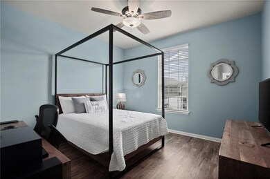 Bedroom with dark wood-style flooring, a ceiling 