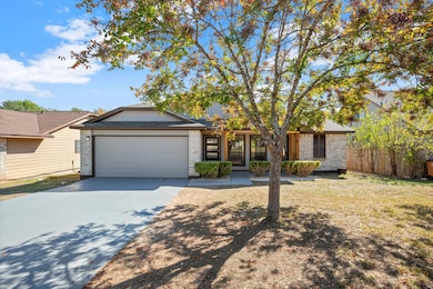 View of front of home featuring brick siding, concrete driveway, and an attached garage