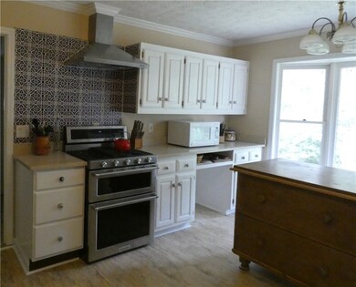 Tile backsplash and gas stove.